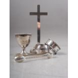 A Mappin & Webb silver egg cup, two silver napkin rings, a pair of sugar tongs and a filled silver