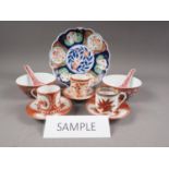 Seven Chinese rice bowls with red polychrome decoration, six similar rice spoons, an Imari plate,