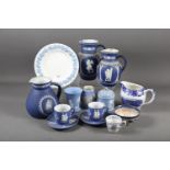 A Wedgwood dark blue jasperware jug, 6 1/4" high, two other similar jugs, a Wedgwood light blue