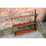A 19th century mahogany waterfall three-tier open bookcase, on turned supports, 33" wide x 8" deep x