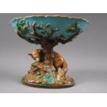 A 19th century Georges Jones Majolica comport, formed as a fox under a tree, 7 1/2" high (damages)
