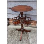 A walnut circular top book table, on turned column and tripod splay support, 17" dia x 30" high