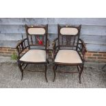 A pair of late 19th century walnut and bone line inlaid saloon elbow chairs with padded seats and