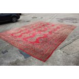 A vintage Turkey carpet of traditional design on a red ground, 166” x 139” approx