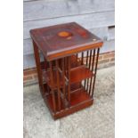 A mahogany and inlaid revolving two-tier bookcase, 18" square x 31 1/2" high