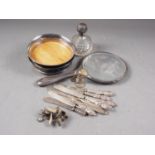 A pair of silver bottle coasters, a silver backed hand mirror, a silver and cut glass scent bomb and