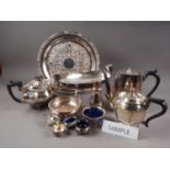 An assortment of silver plate, including two teapots, a pair of trays, a sugar shaker, a wine