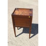 An early 19th century provincial oak tray top bedside cupboard with lift up front, on square taper