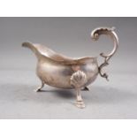 A silver sauce boat with scrolled handle and three hoof feet, London 1765, 8.4oz troy approx