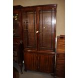 An Edwardian mahogany bookcase enclosed two glazed doors over two cupboard doors, 39 1/2" wide x 15"