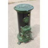 A Godin green and black enamel stove (gas fired), 14" dia x 30" high, on scroll feet