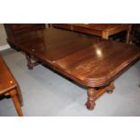 A late Victorian mahogany extending dining table with two extra leaves, on four corner supports