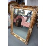 A rectangular shaped wall mirror with bevelled plate, 19 1/2" x 29 1/2", in ornate gilt frame