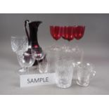 A ruby and clear cut glass jug, whisky tumblers, wines and other glassware