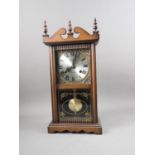 An early 20th century mahogany cased 31-day drop dial clock with silvered dial and Roman numerals,