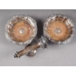 A pair of silver plated bottle coasters with turned wood bases and a plated wall mounted candle