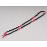 An onyx and red coral bead necklace with diamond pedant, .24ct approx, 15 1/2" long