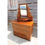 An Edwardian walnut dressing chest, fitted mirror over jewel drawer and three graduated long