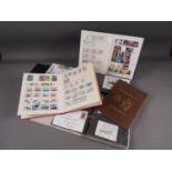 Two albums of British stamps, an album of world stamps and two albums of first day covers