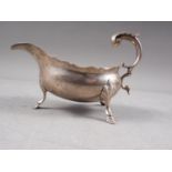 A silver sauce boat with scrolled handle and three hoof feet, London 1787, 6.1oz troy approx