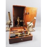 A 19th century brass pillar microscope, in case, a brass microscope, in case, and two other