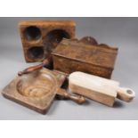 An elm candle box, 13" wide, two similar elm dishes, a pestle and a spice box