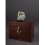 A Chinese carved pale jade figure group, 2 1/2" high, on stand, in a hardwood hinged box