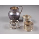 Three silver napkin rings, 1.7oz troy approx, and a silver cream jug, 2.2oz troy approx
