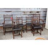 A set of nine late 19th century oak turned frame dining chairs, the seven side chairs with stuffed