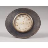 An engine turned silver framed strut clock with silvered dial and Arabic numerals