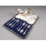 A set of six silver Art Deco style teaspoons and sugar tongs, in fitted case, a silver sauce boat