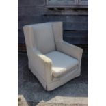 A late 19th century square arm deep seat chair with loose seat cushion and linen covers, on turned