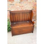 An oak box seat settle with chip carved top rail, on panel end supports, 36" wide x 17" deep x 36"