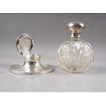 A cut glass scent bomb with silver lid and a silver capstan inkwell