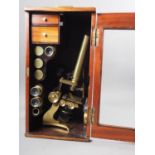 A Stanley brass microscope with additional lenses, etc, in a fitted case