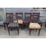 A Harlequin set of six Edwardian walnut dining chairs with shell carved top rails and stuffed over