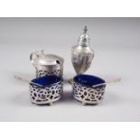 A silver three-piece cruet with blue glass liners and a silver half fluted pepperette, 2.5oz troy