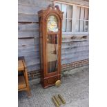 An oak long case clock with eight-day striking and chiming movement, enclosed glazed door, 77"