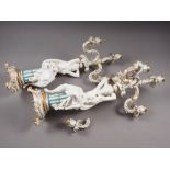A pair of Continental porcelain four-light candelabrum, formed as figures with a putto, 23 1/2" high
