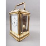 A French gilt and brass repeating carriage clock with bevelled glass, white enamelled dial and Roman