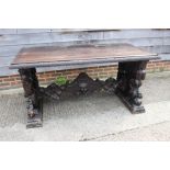 A mid Victorian carved walnut centre table of 17th century design, figure and scroll panel end