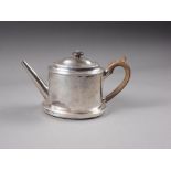 A Georgian silver oval shaped teapot of plain design with hardwood handle and knop, and a matched