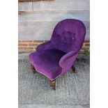 A late 19th century tub-shape occasional chair, button upholstered in a purple velour, on turned and