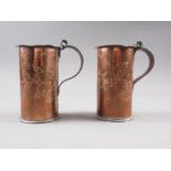 A pair of Newlyn copper mugs, decorated leaves and flowers, 4 1/2" high