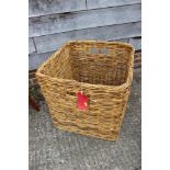 A wicker log basket, 24" wide x 24" deep x 24" high