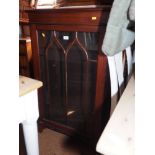 A mahogany display cabinet, enclosed Gothic lattice glazed door, on bracket feet, 26" wide x 14"