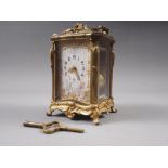 A late 19th century French bronze and bevelled glass repeating carriage clock with enamelled dial,