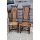 A pair of polished as walnut cane seat and back chairs of 17th century design, on turned and