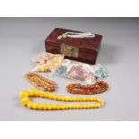 A quantity of loose Baltic amber beads, other loose beads, contained in a Japanese red lacquered