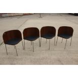 A set of four chrome framed bentwood chairs with black vinyl seats